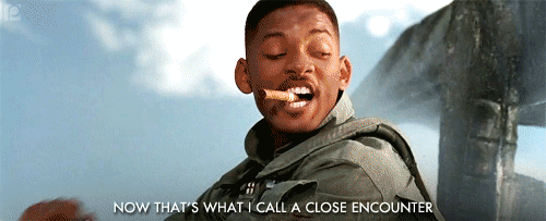 Will Smith smoking a cigar, captioned "Now that's what I call a close encounter" after punching an alien in Independence Day.