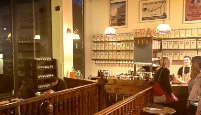 Quilliam Brothers, Newcastle Inside a warm and inviting tea house with a wall full of tea canisters.